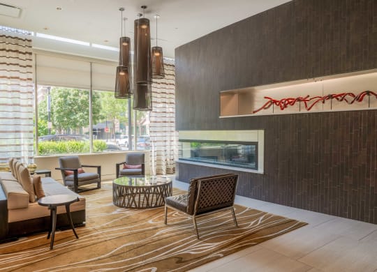 a living room with a couch and chairs and a fireplace at The Acadia at Metropolitan Park, Virginia, 22202